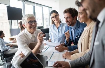 Group of young business people working and communicating at the office